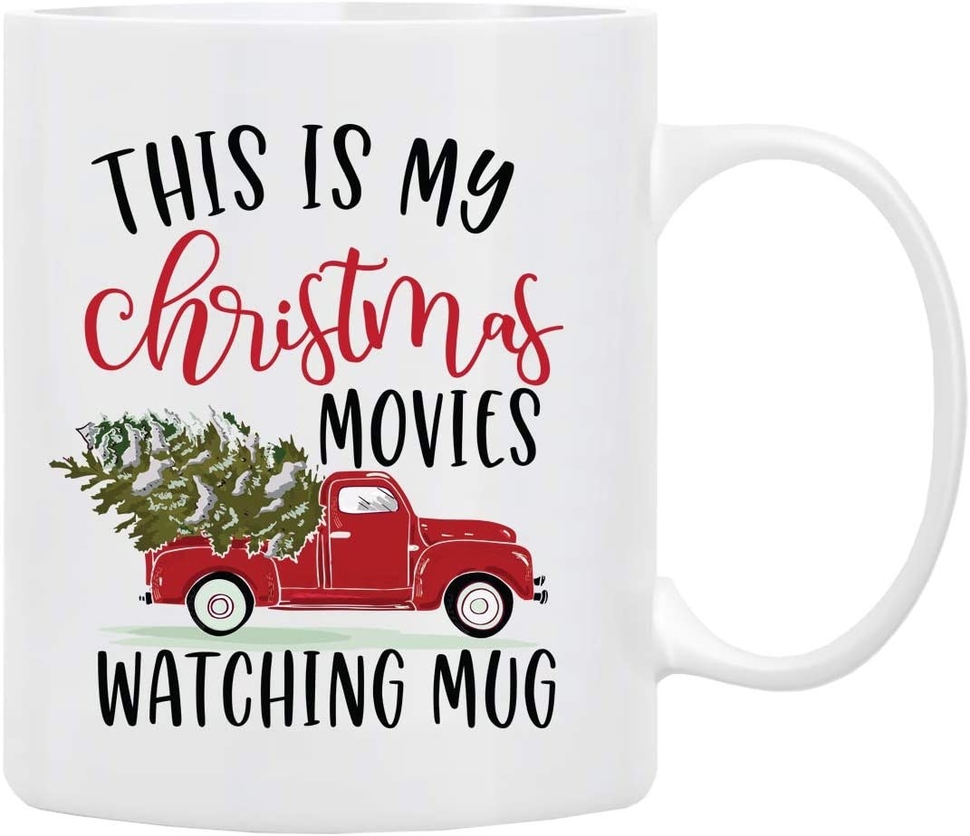 The white mug with a pickup truck holding a christmas tree and text &quot;this is my christmas movies watching mug&quot;