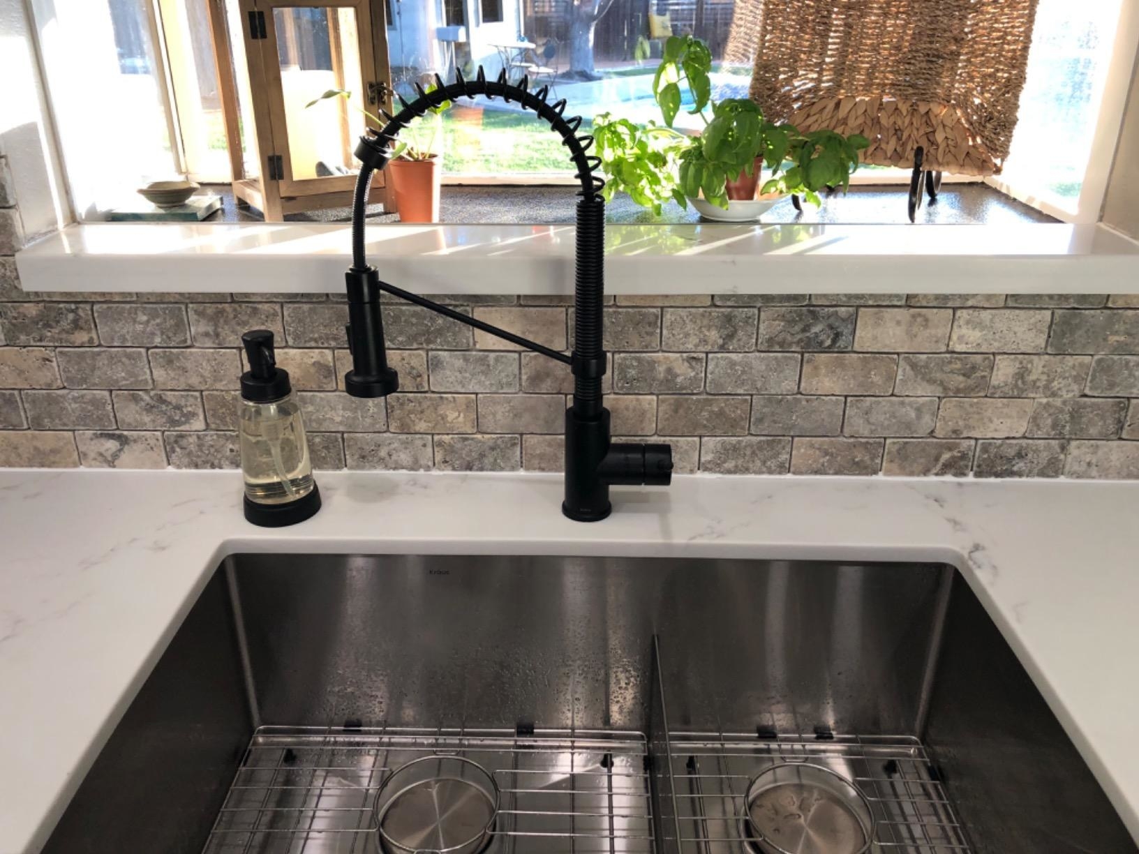 Reviewer image of black faucet in their kitchen