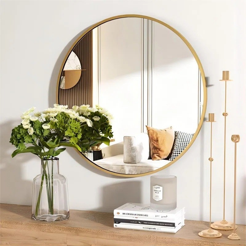 the gold mirror above a console table