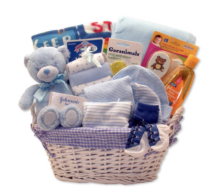 Teddy bear, baby shampoo, baby brush and comb, garanimals chill and chew teethers, and other baby items in basket