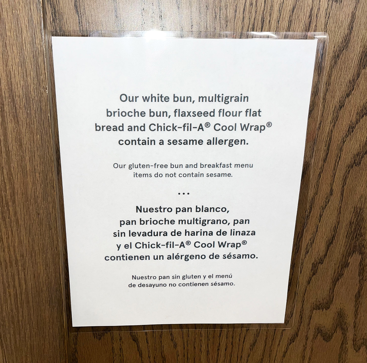 A sign on a door reads &quot;Our white bun, multigrain brioche bun, flaxseed flour flat bread and Chick-fil-A cool wrap contain a sesame allergen&quot;