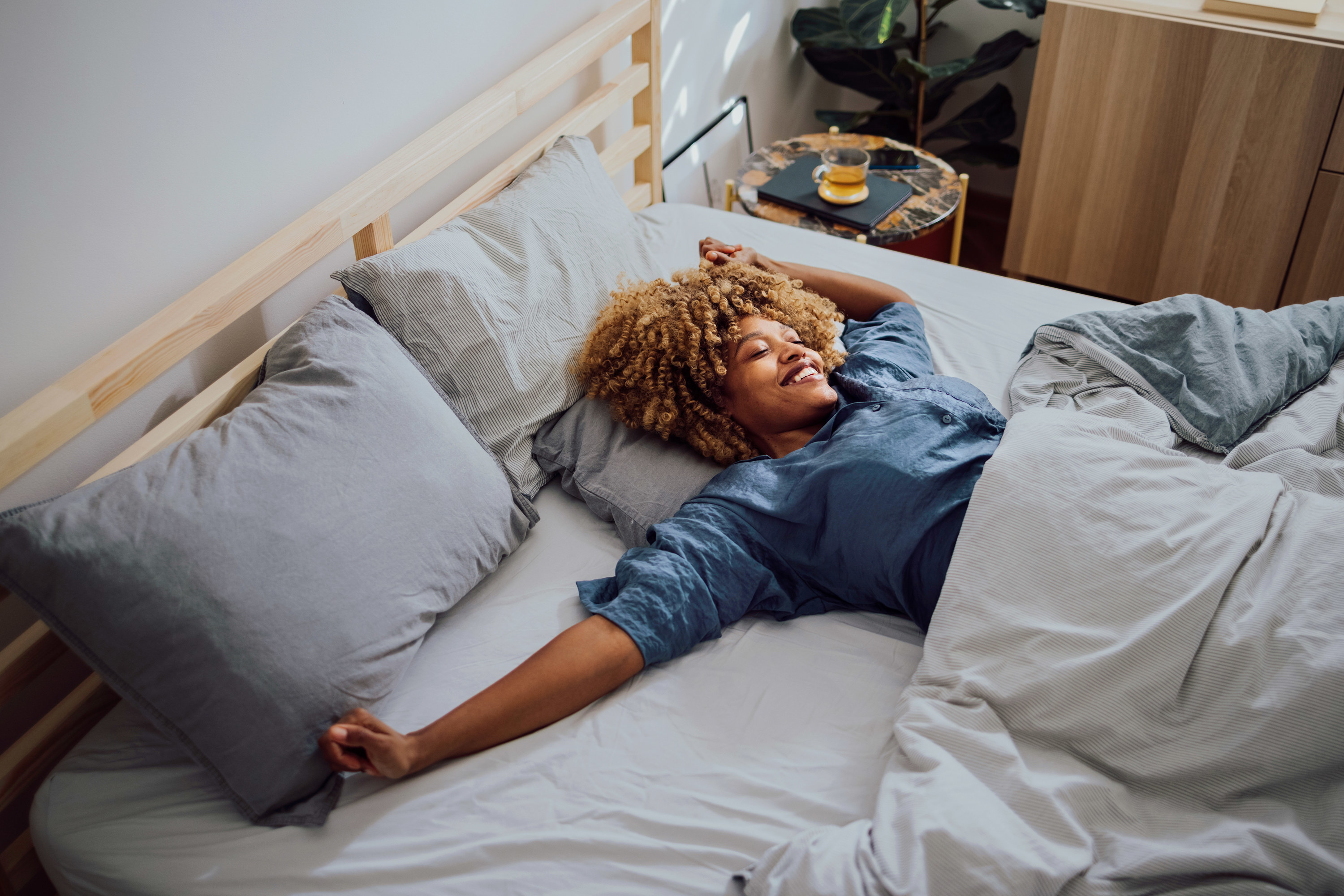 a woman smiling in bed