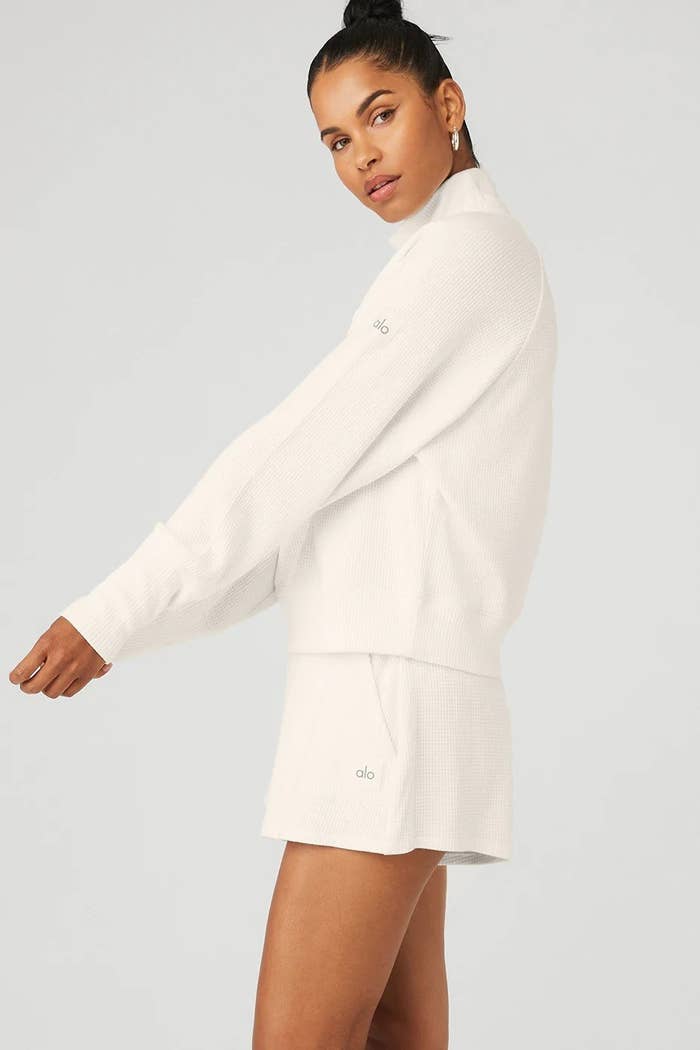 model wearing white thermal top with matching shorts