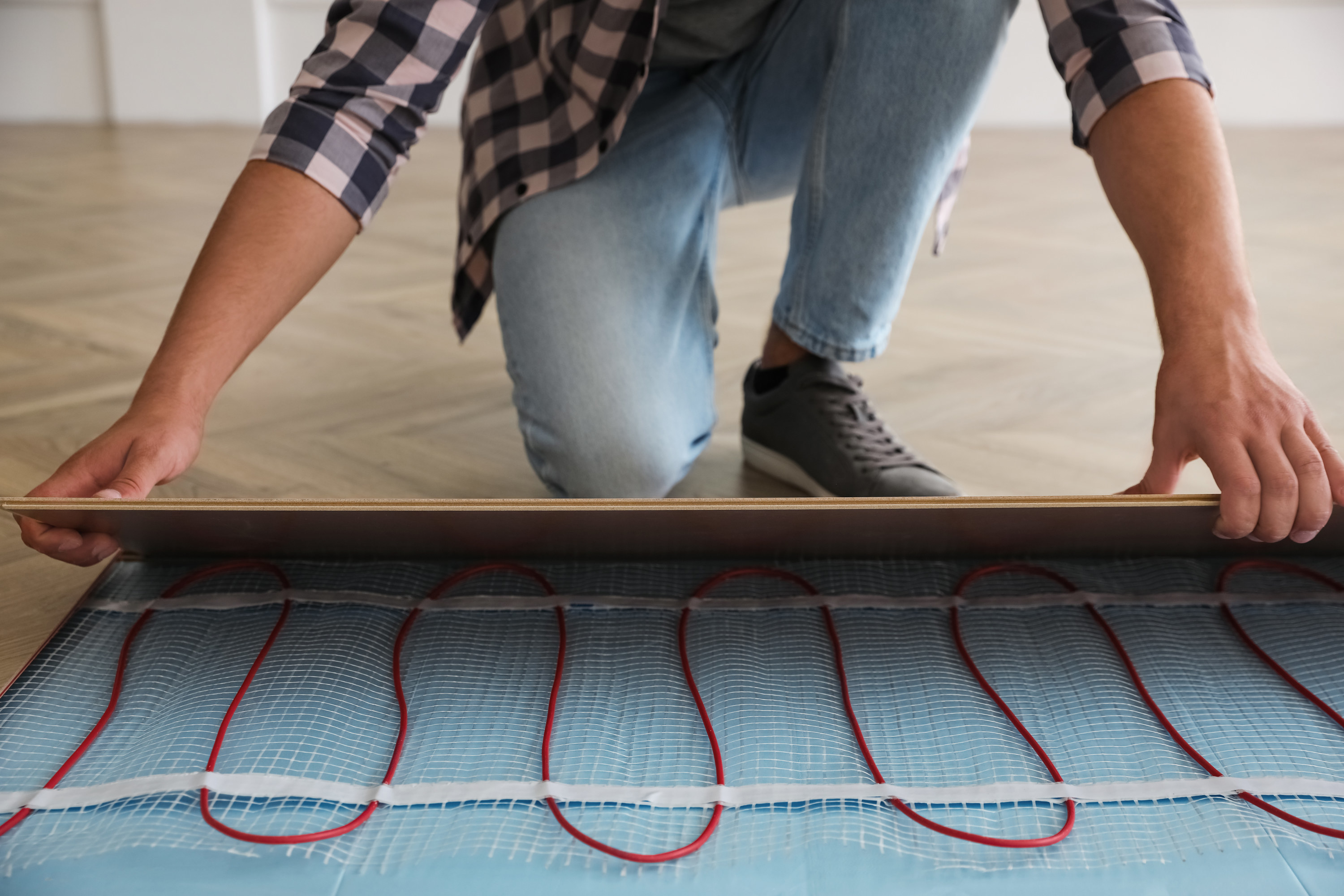 Man installing heated floors