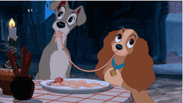 Two dogs sharing a piece of spaghetti in &quot;Lady and the Tramp&quot;