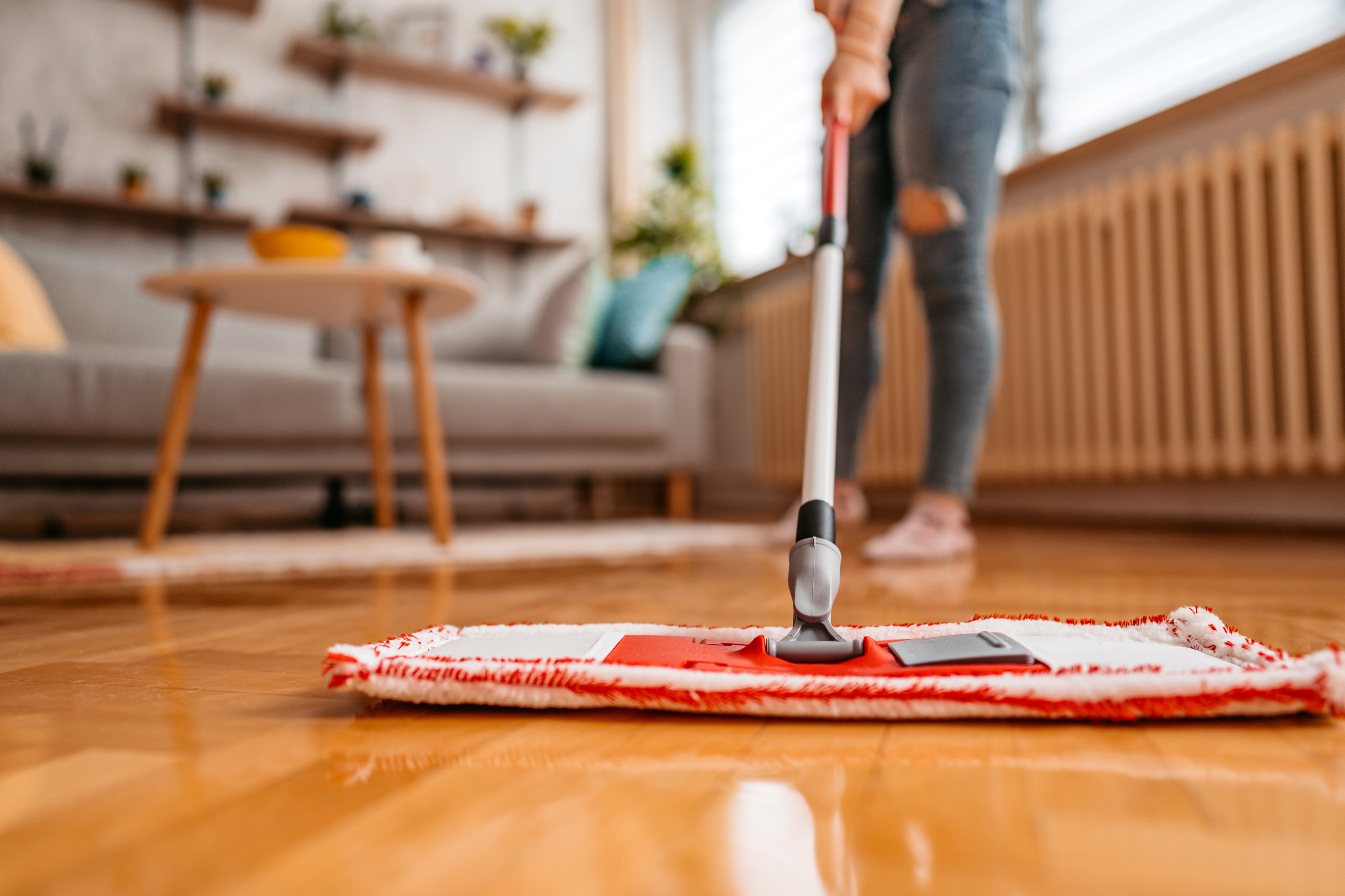 Person mopping a wood floor