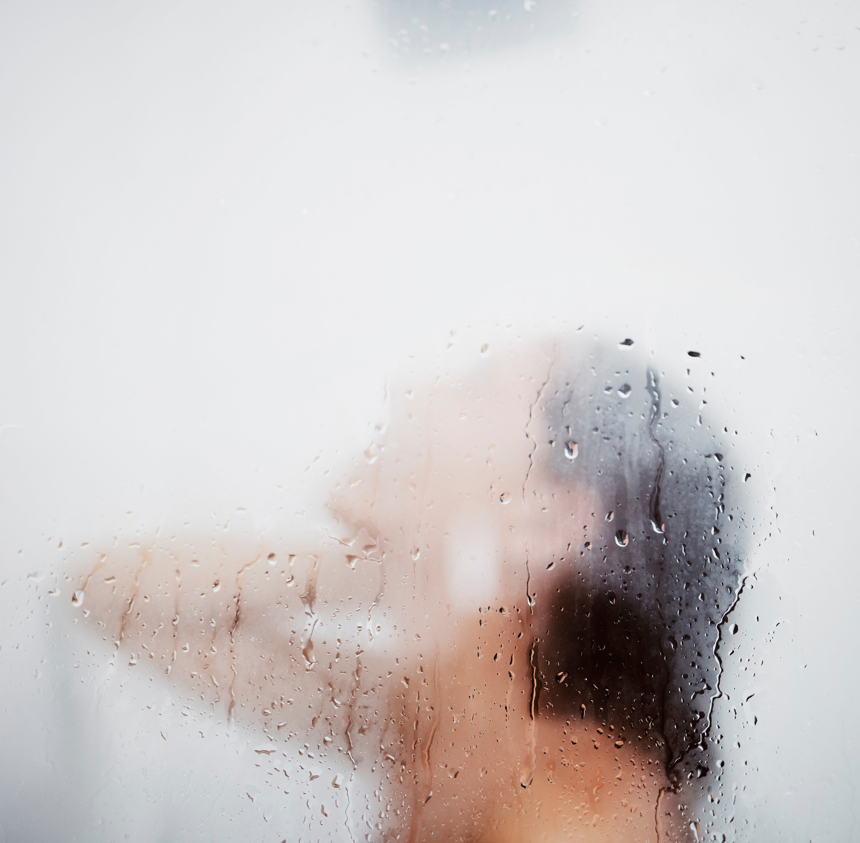 Woman washing her hair in a steamy shower