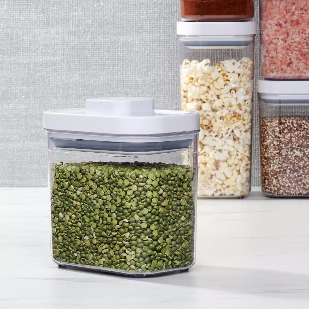The container on a countertop with edamame