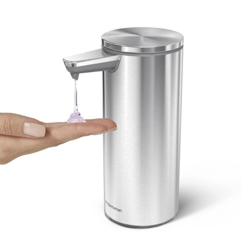 The silver dispenser says &quot;simple human&quot; and has a clear purple liquid coming out