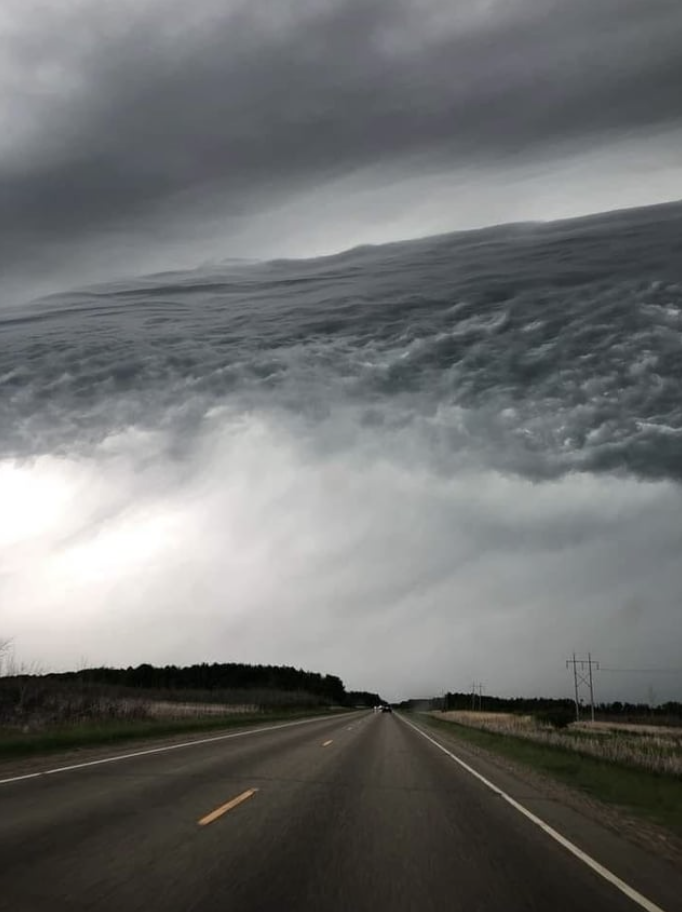 clouds that look like water hovering over a road