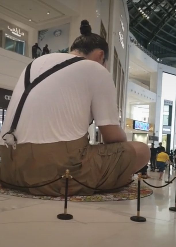 real-life looking statue in a sitting position