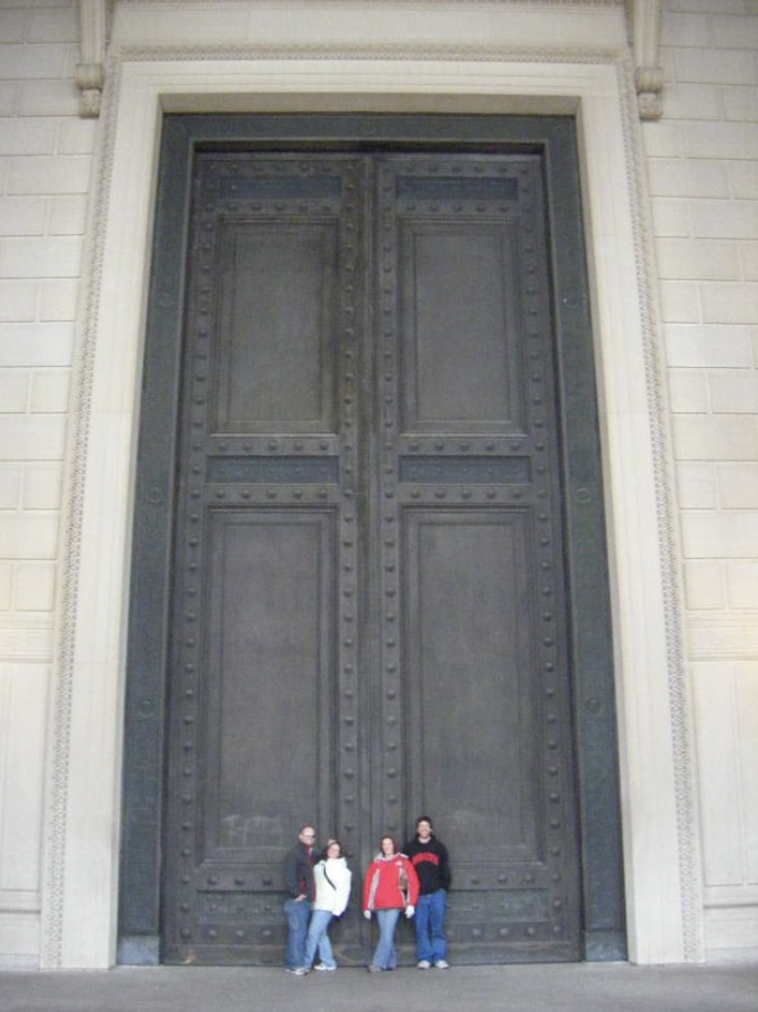 people standing in front of the large doors
