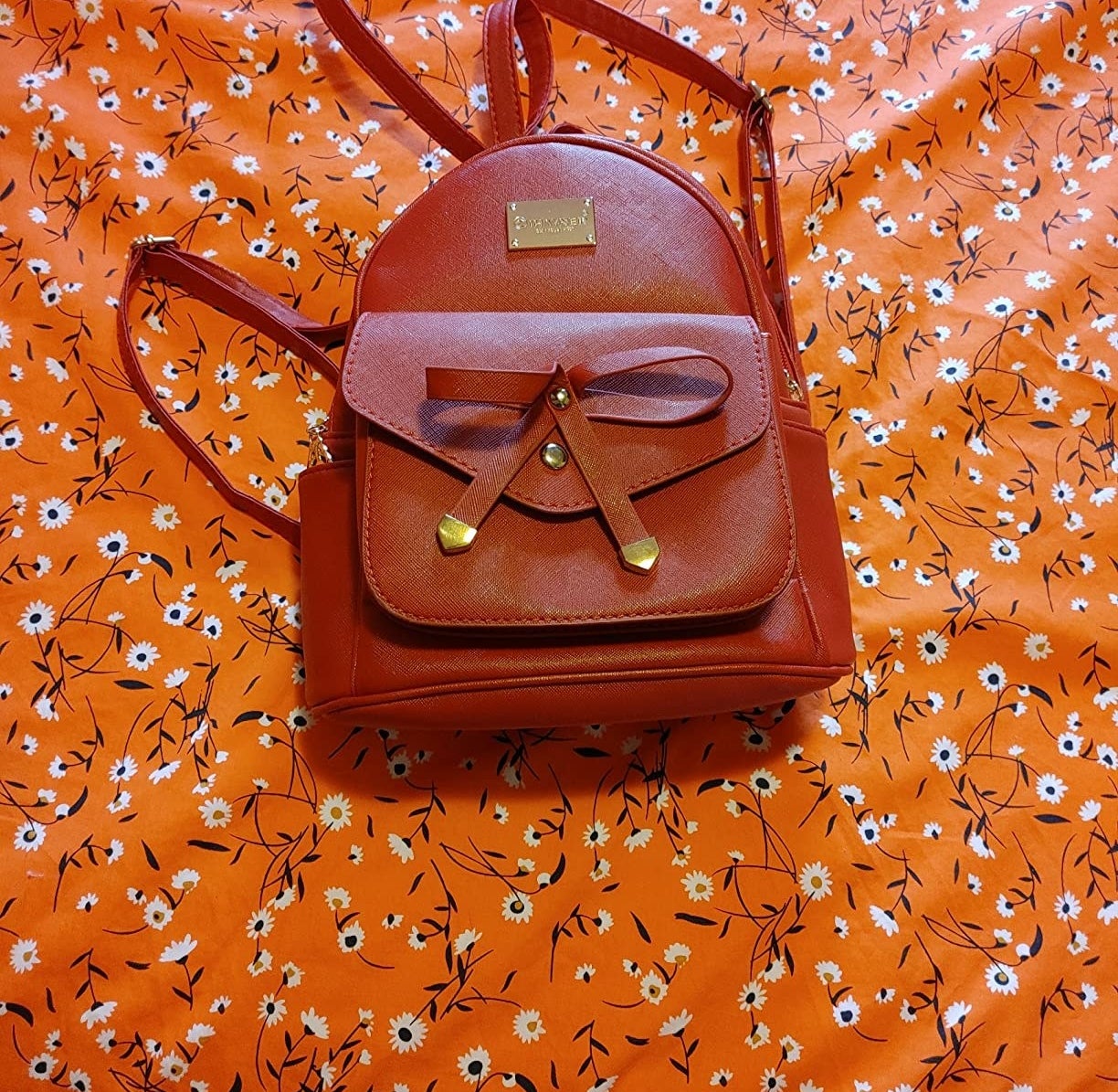 Reviewer&#x27;s rust colored backpack