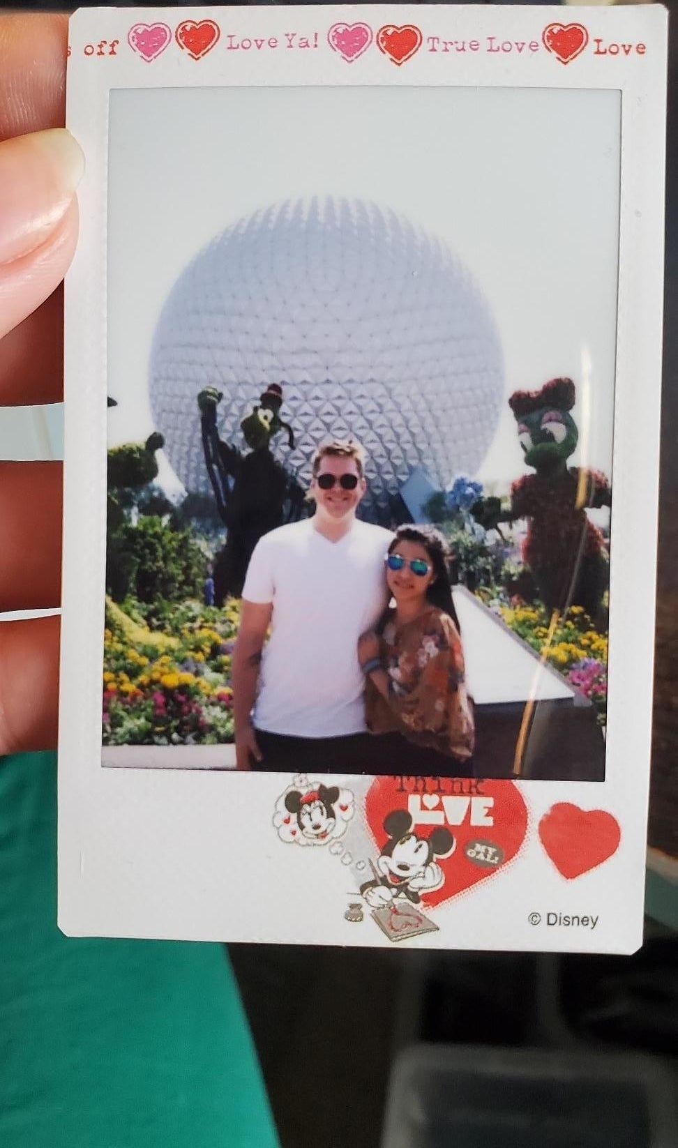 a reviewer&#x27;s instant film photo with a mickey and minnie design around it
