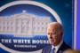 Biden is seen in front of a White House logo