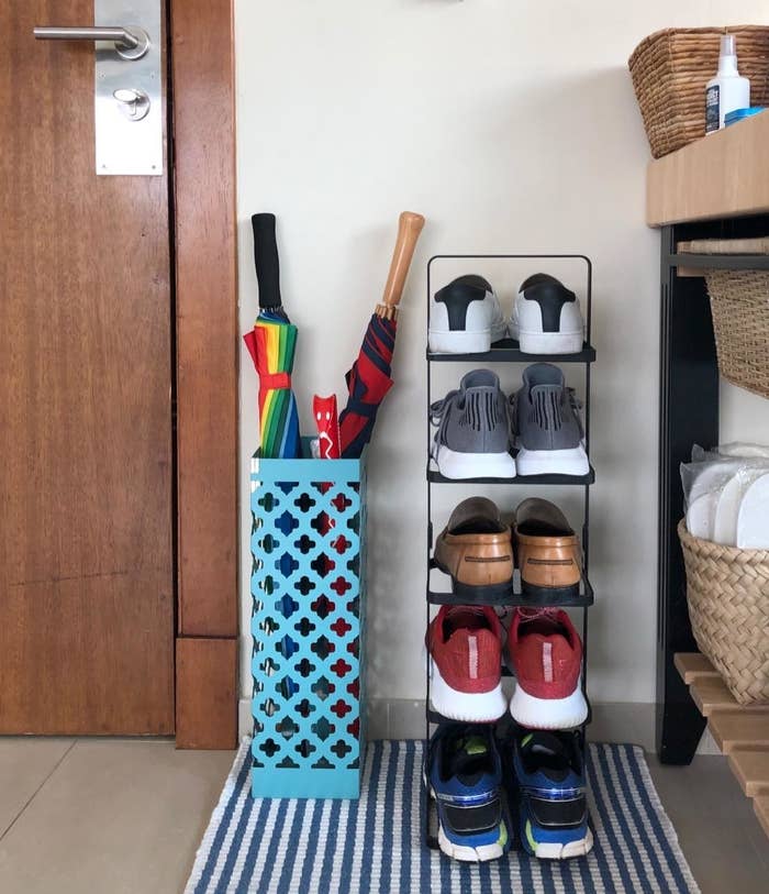 a reviewer photo of the shoe tower loaded with shoes sitting in a small entryway