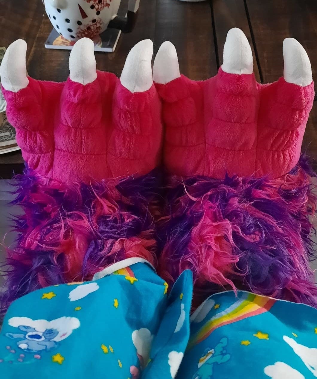 reviewer&#x27;s photo of the red and purple claw slippers