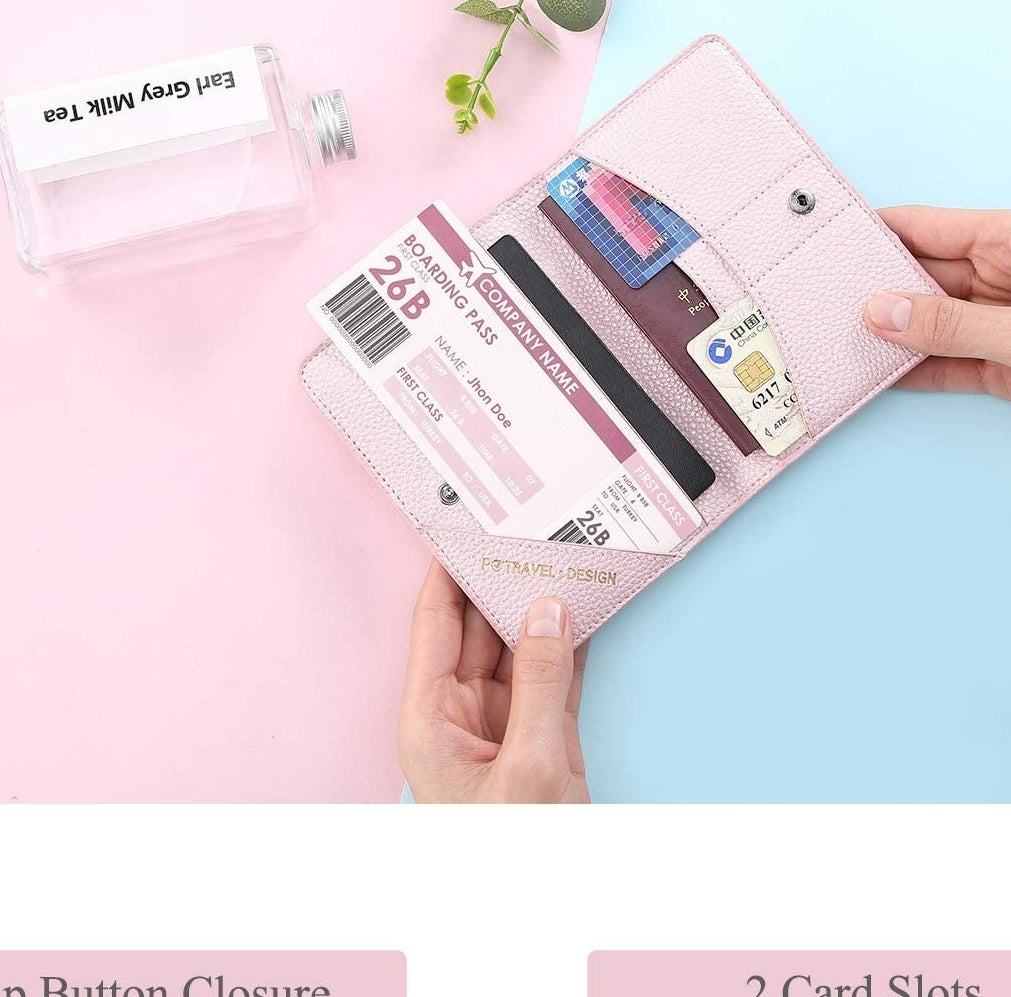 a person opening the travel wallet to show off the documents inside all the compartments