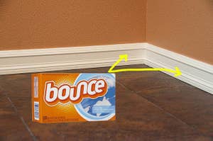 A box of dryer sheets with arrows pointing to base boards