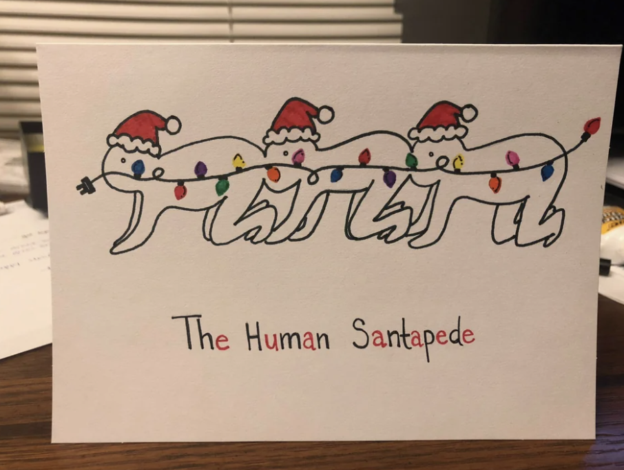 Three people wearing Santa hats with their mouths on the butt of the person in front of them, with text that says &quot;The Human Santapede&quot;