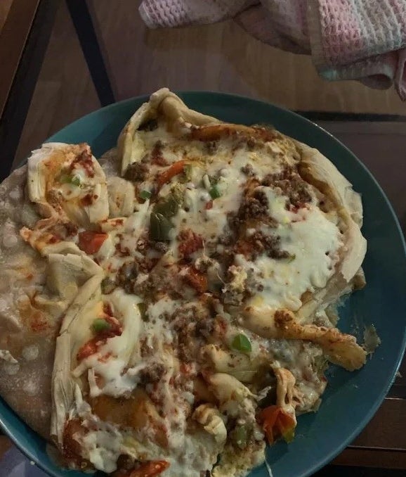 pizza melted in a mess on a plate