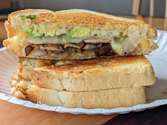 Grilled cheese sandwich with avocado, mushrooms and onions.