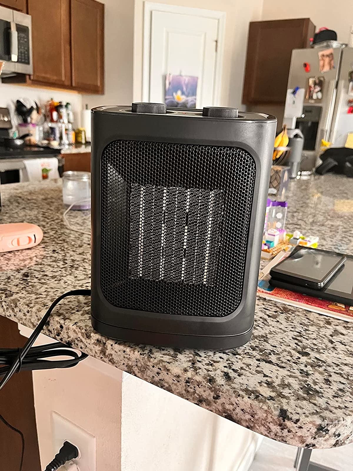 Reviewer image of portable space heater sitting on their countertop