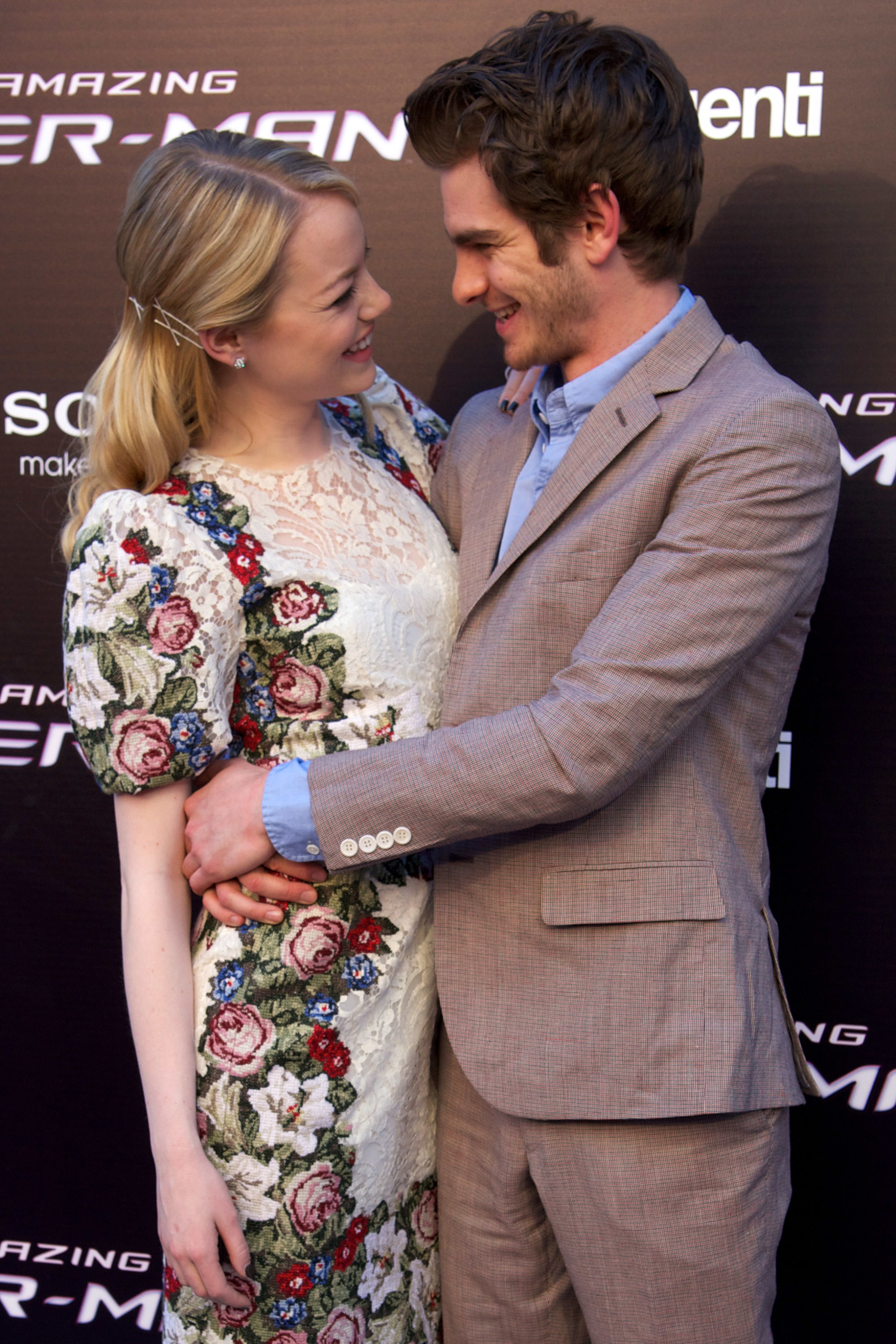 Emma Stone and Andrew Garfield with their arms around each other and smiling