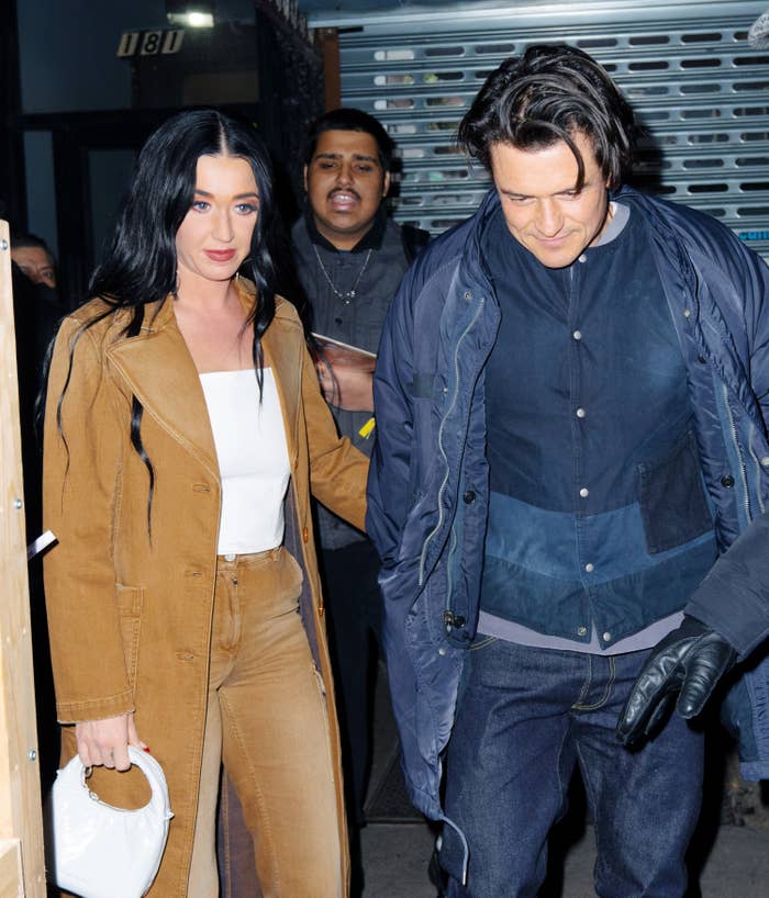 Katy Perry and Orlando Bloom holding hands and walking