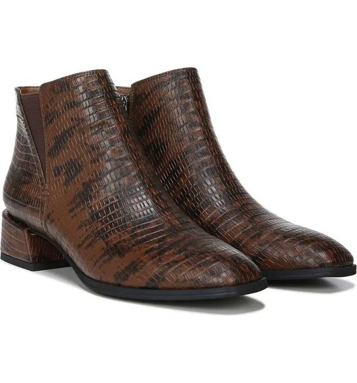 The croc-embossed booties in a black and brown pattern