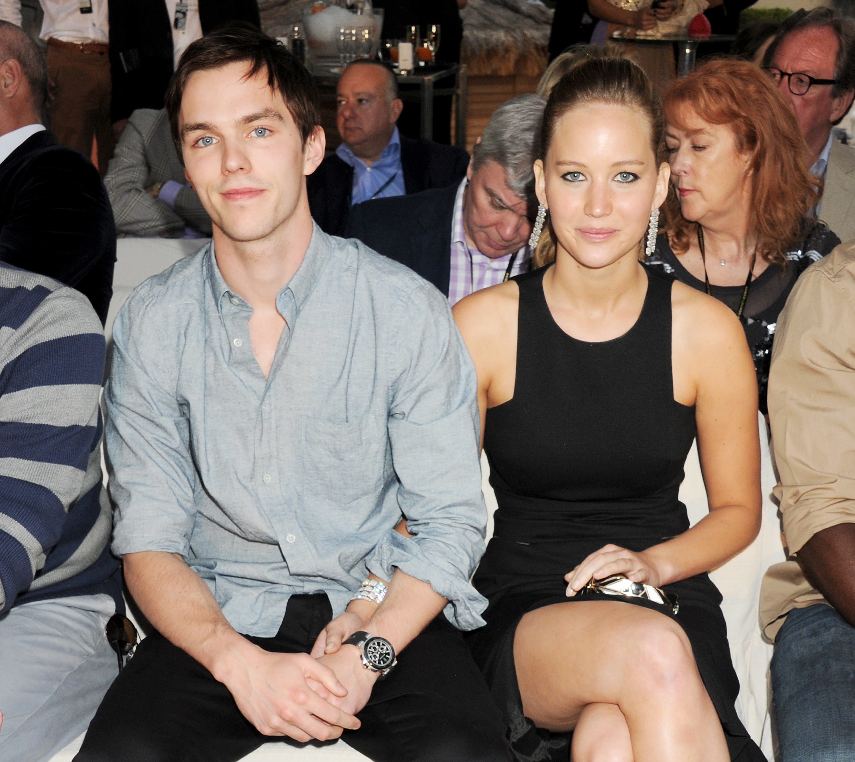 Nicholas Hoult and Jennifer Lawrence holding hands at an event
