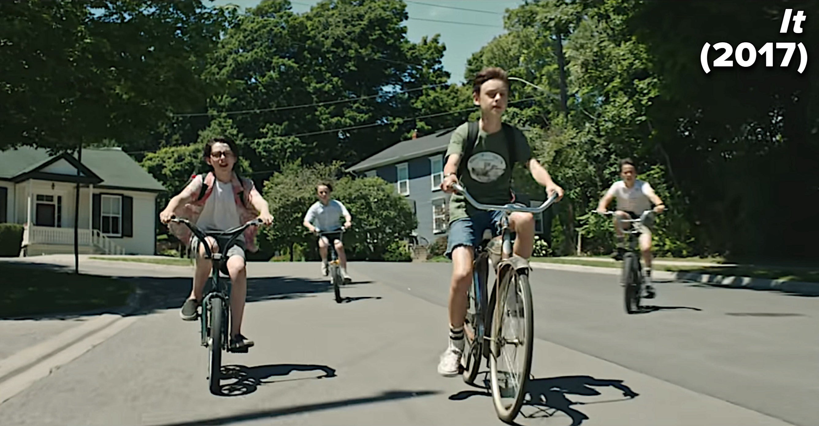 group of kids riding their bikes in the. movie It