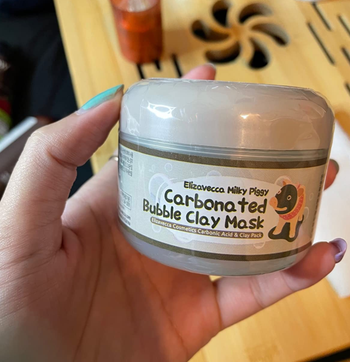 reviewer holding the mask jar