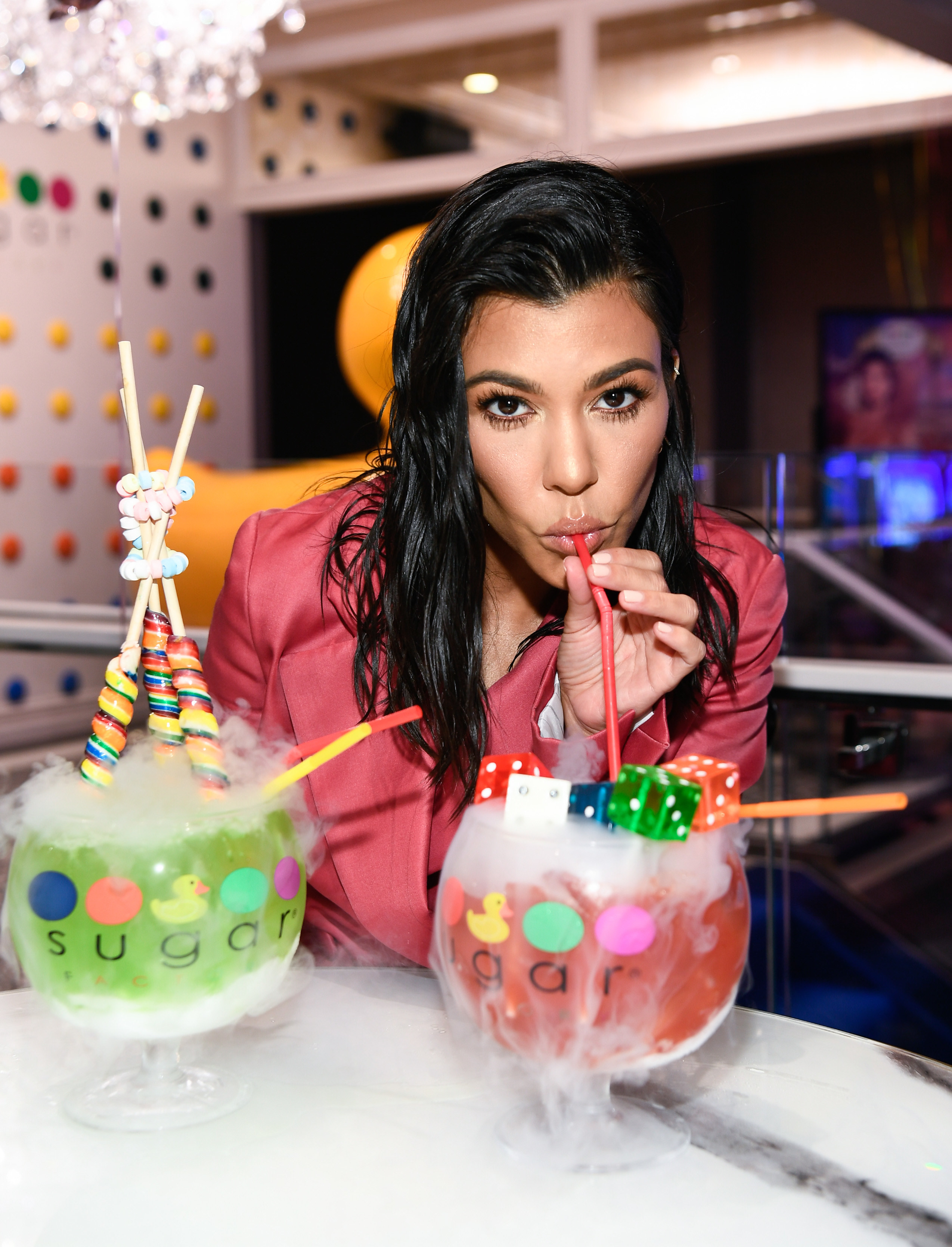 Kourtney drinking a cocktail