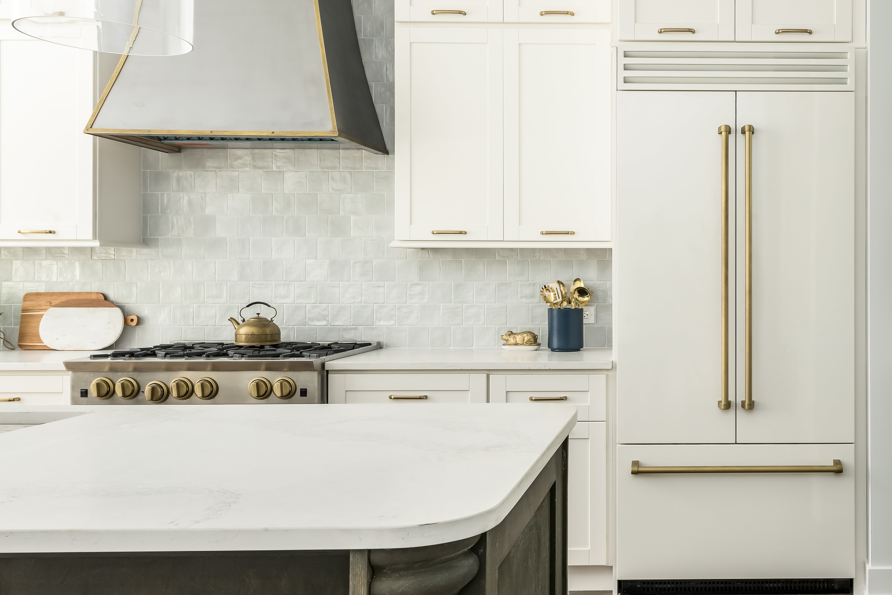 white kitchen with gold hardware, trim, and kitchenware