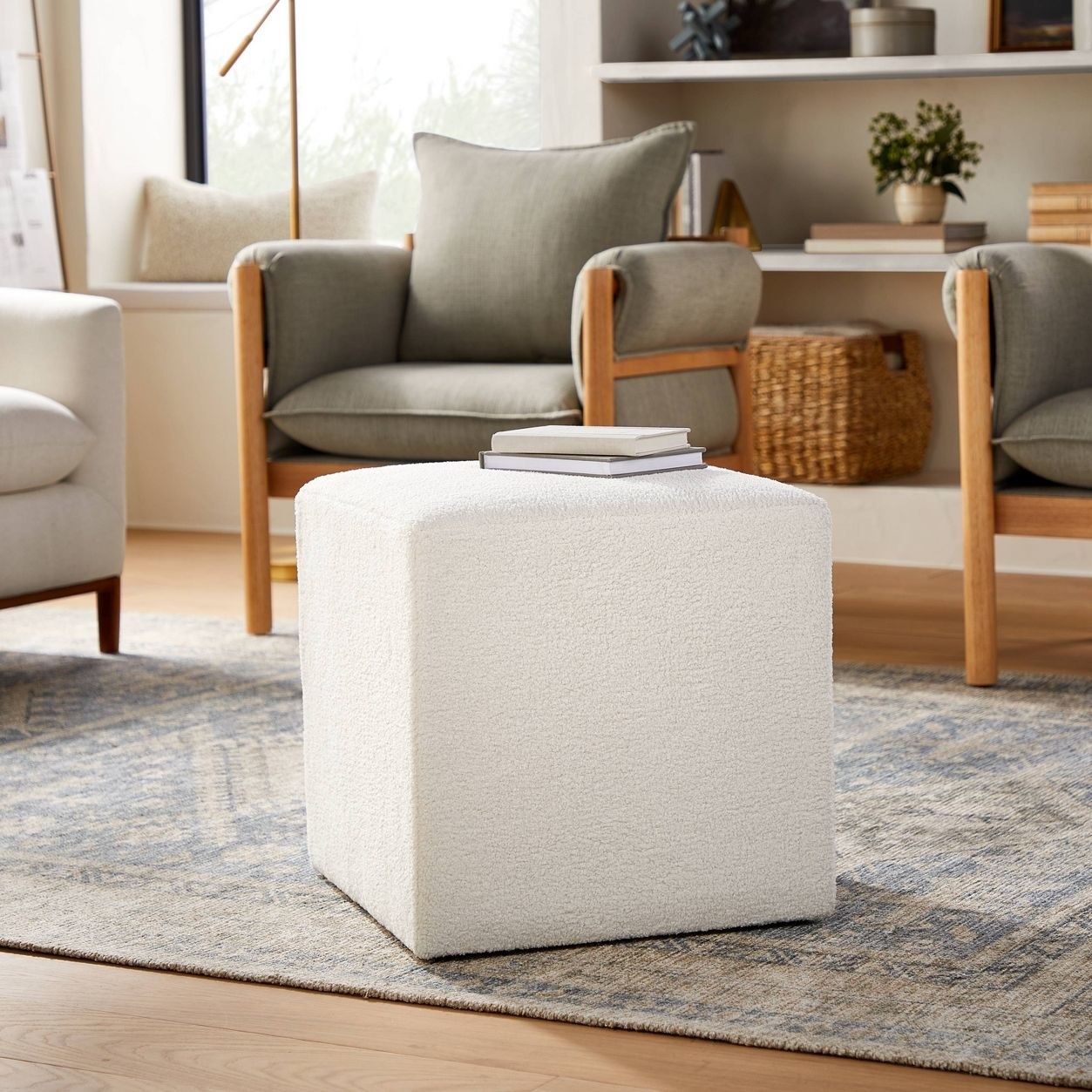 The cube in cream boucle in a living room
