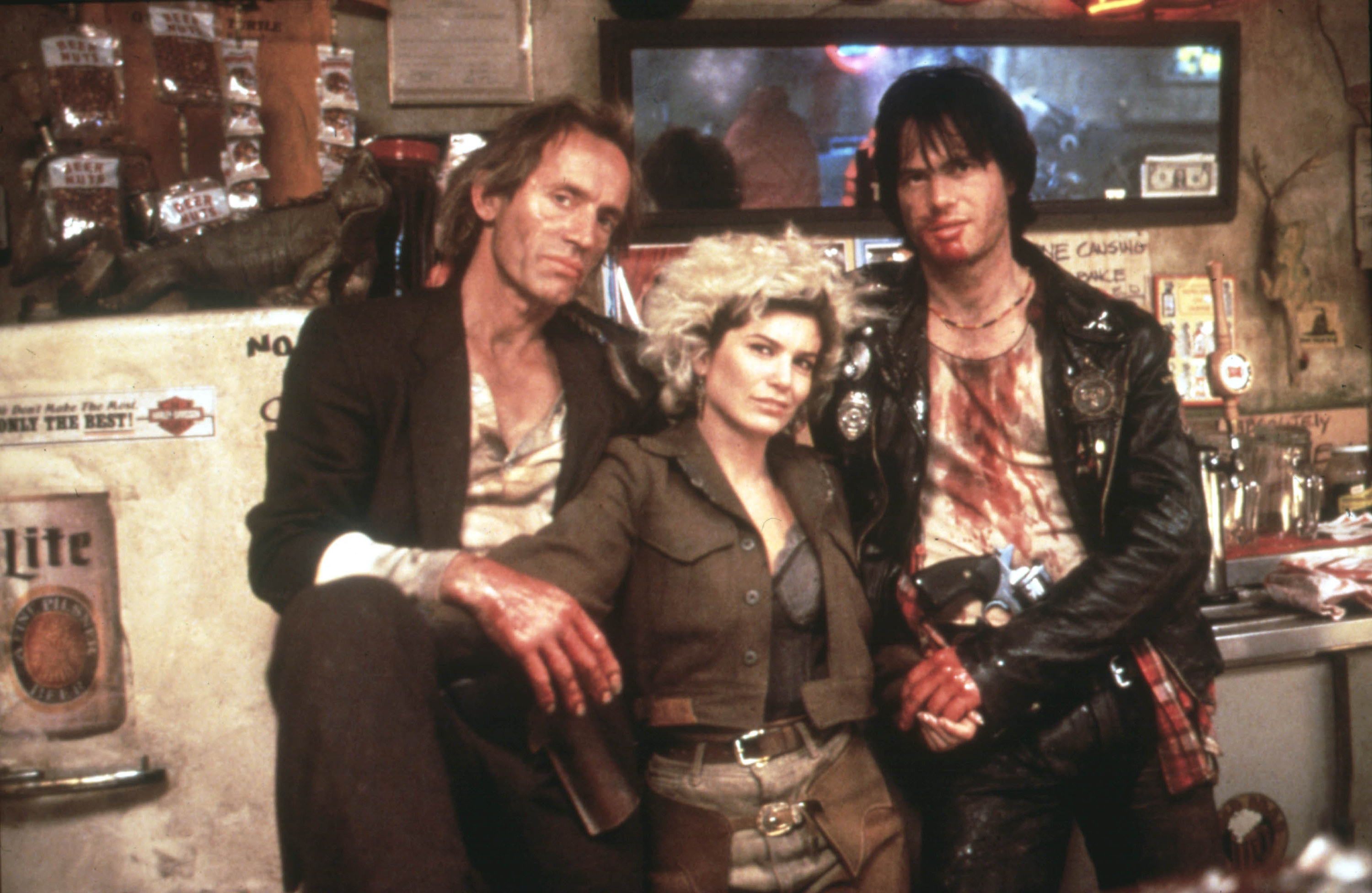 A trio of outlaw vampires stand malevolently in a dirty bar