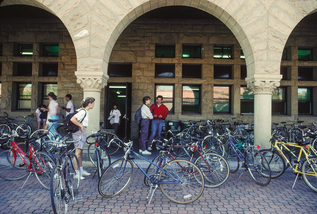 Students on campus with bicycles