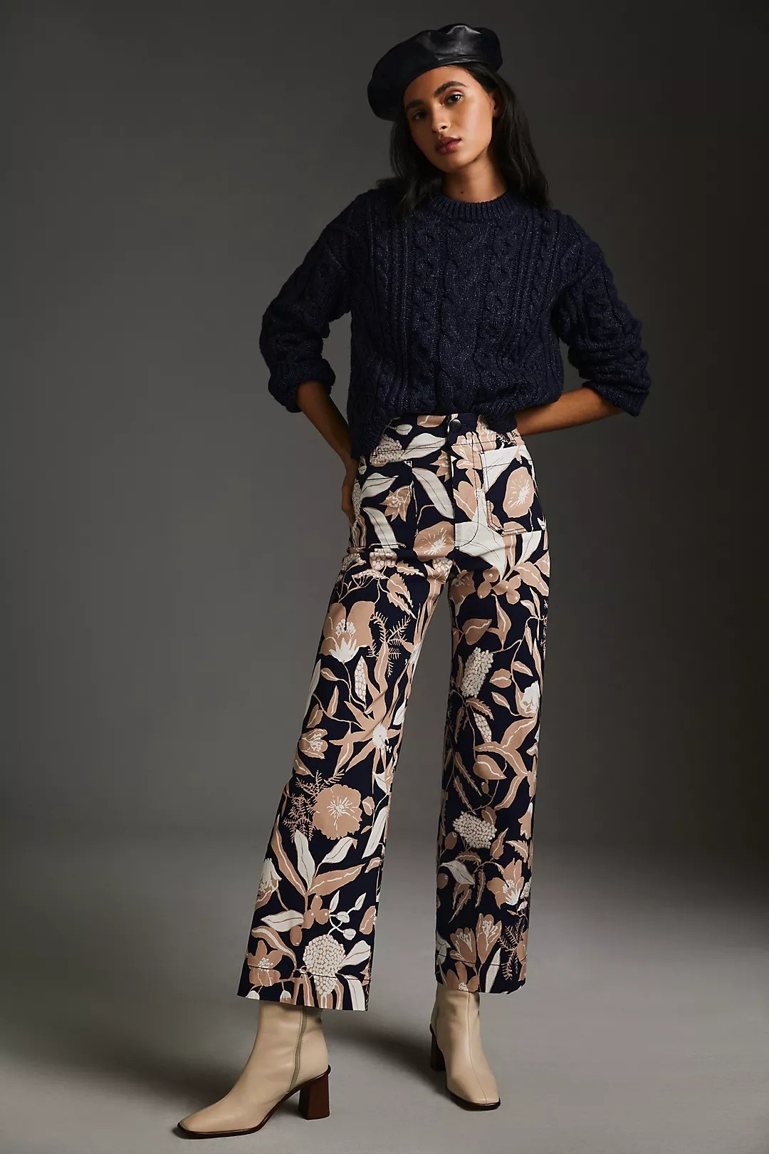 a model wearing the brown, tan and navy leaf patterned pants