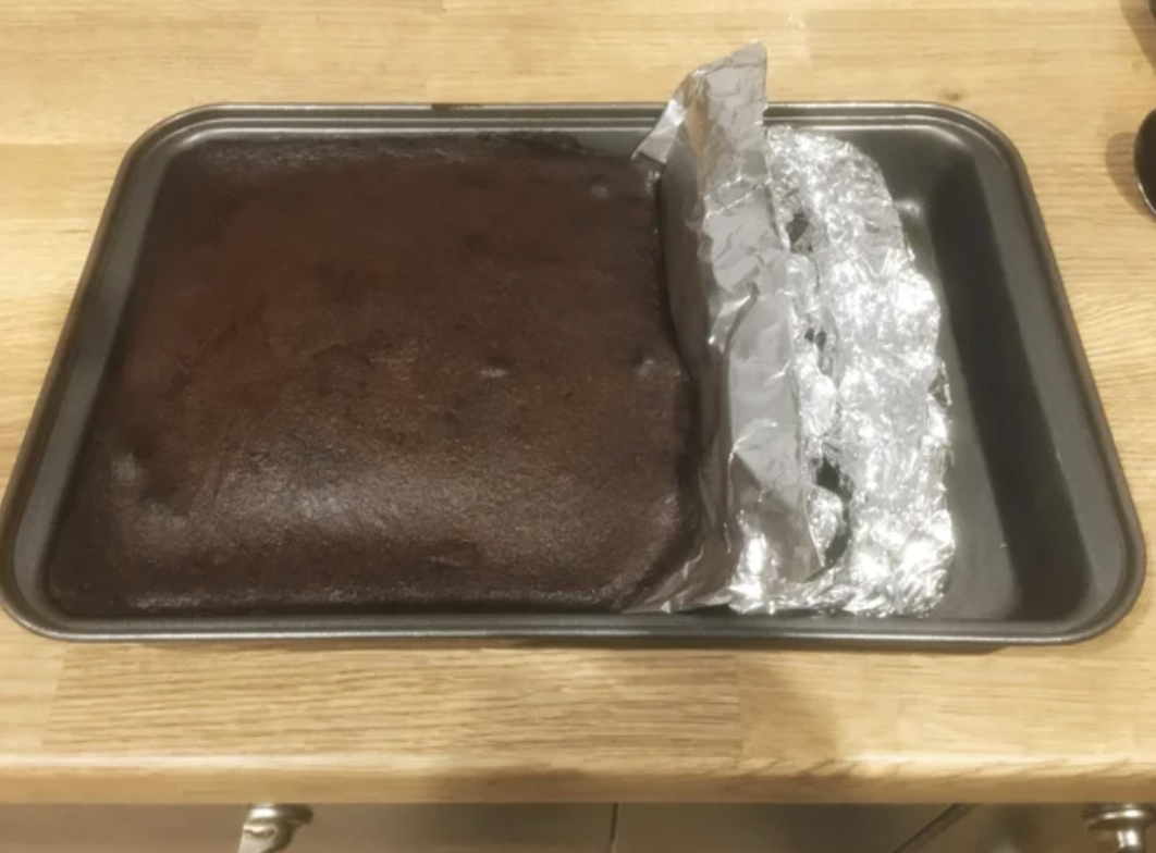 brownies baked in a large pan that&#x27;s been sectioned off with tin foil