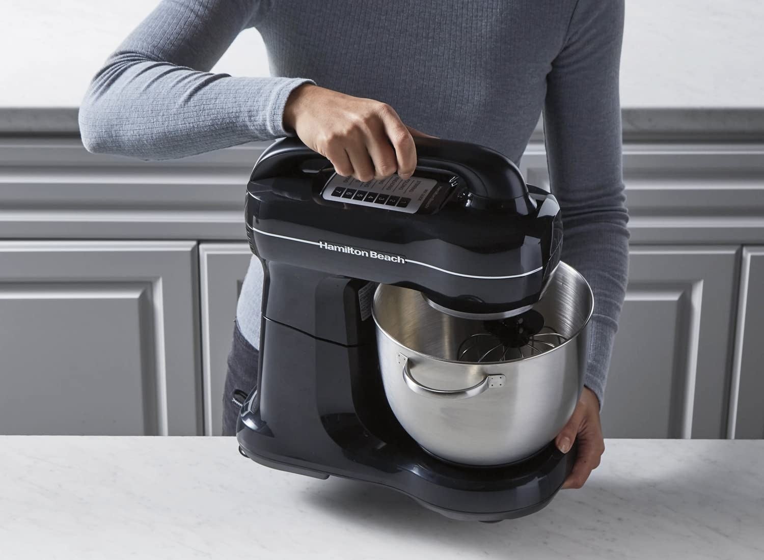 A person using the stand mixer