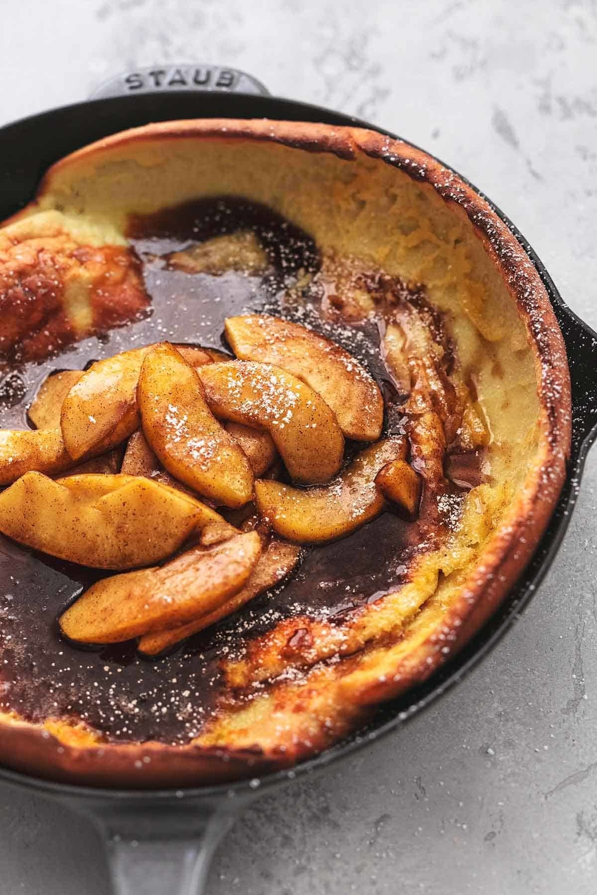 An apple dutch baby in a cast iron skillet.