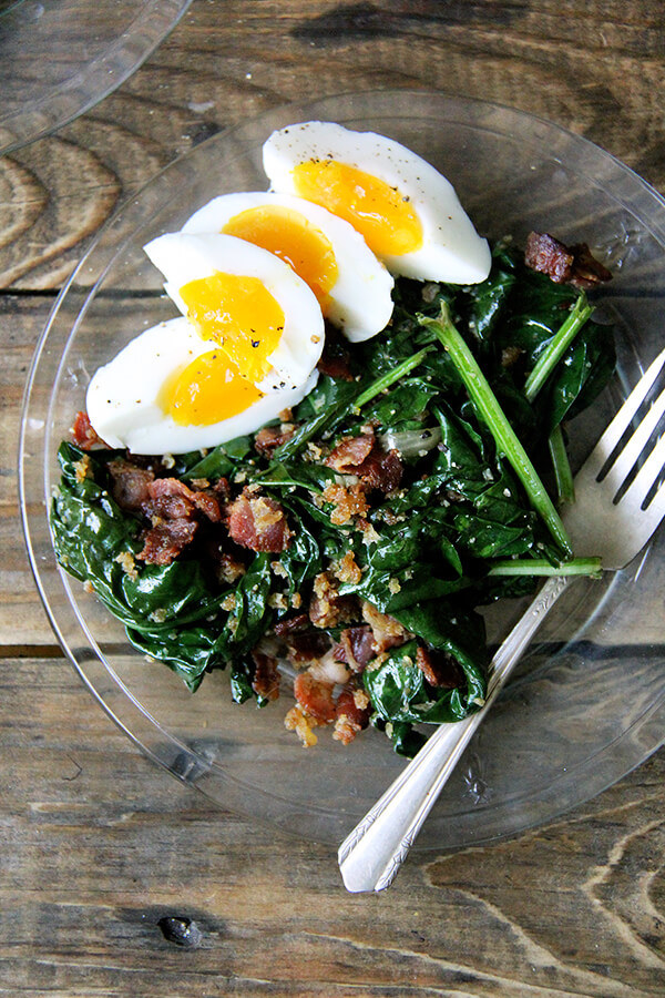 Spinach salad with bacon and soft boiled eggs.
