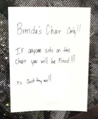 A handwritten sign reads: "Brenda's Chair Only!! If anyone sits on this chair you will be fired!!! P.S. Just try me!!"