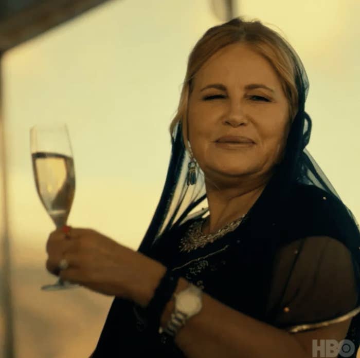 Jennifer Coolidge holding a glass of champagne in The White Lotus