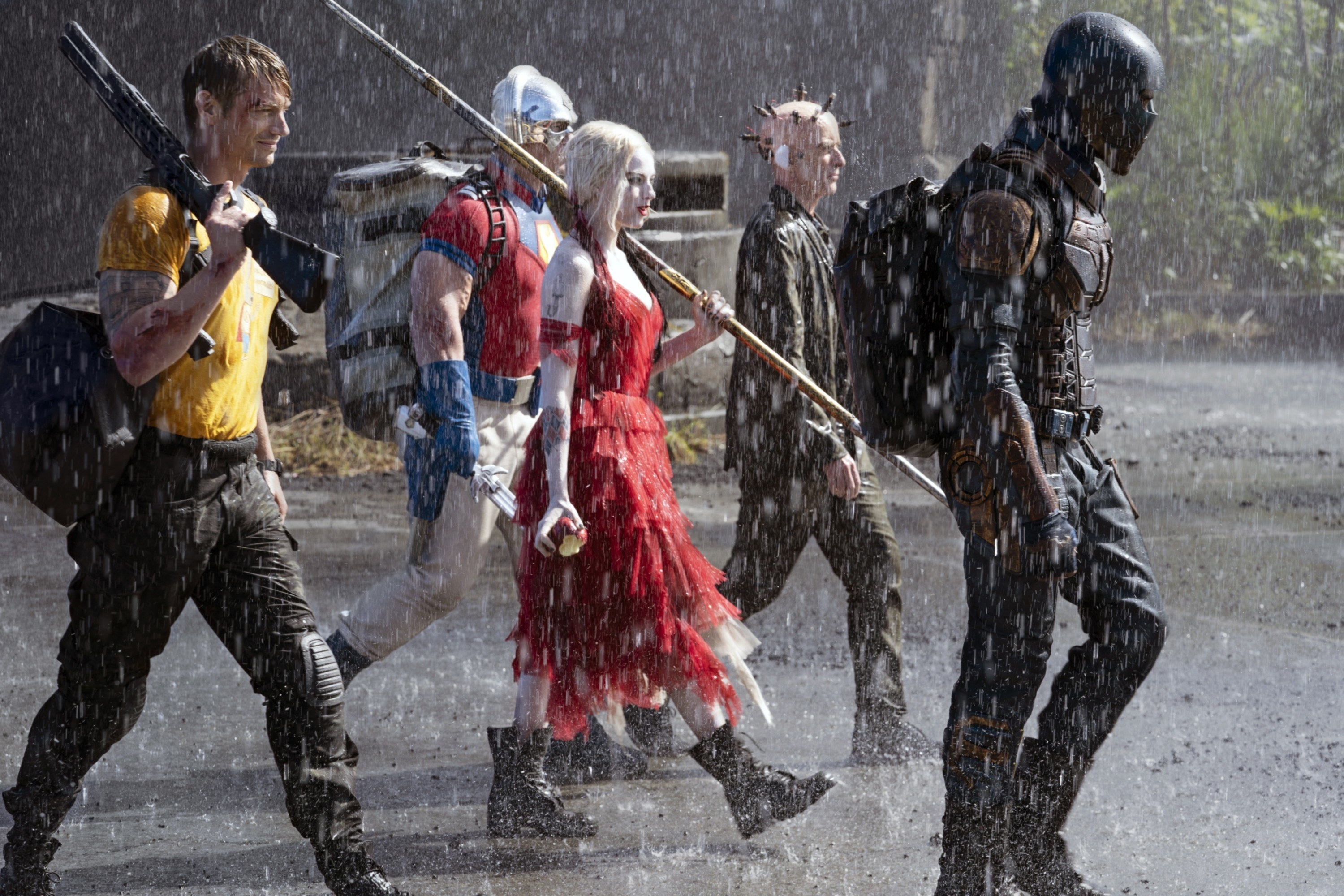 Joel Kinnaman, John Cena, Margot RObbie, Peter Capaldi, and Idris Elba walk in the rain