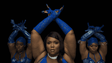 Lizzo and dancers flexing fingers in cobalt lingerie
