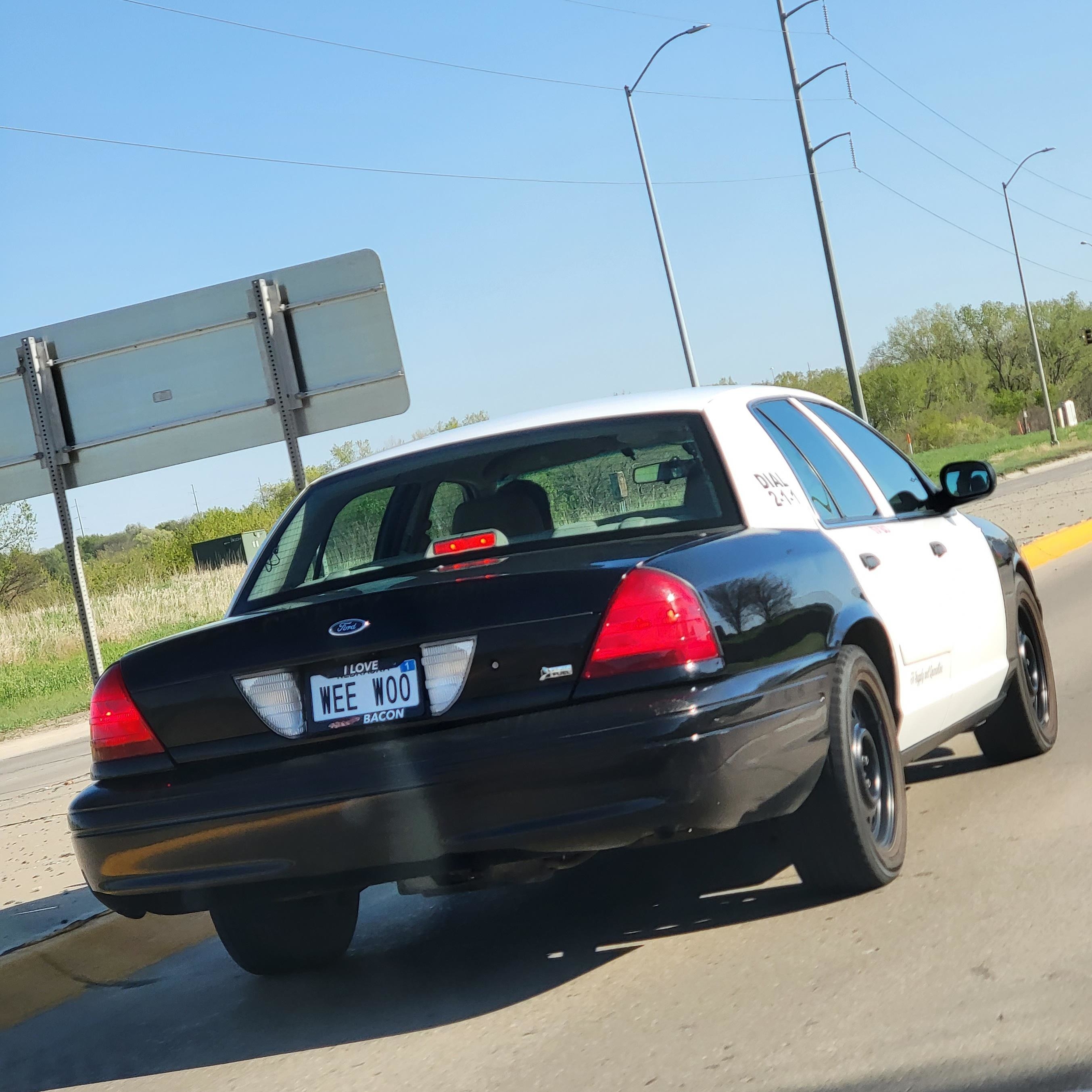 Police car with license plate reading &quot;WEE WOO&quot;