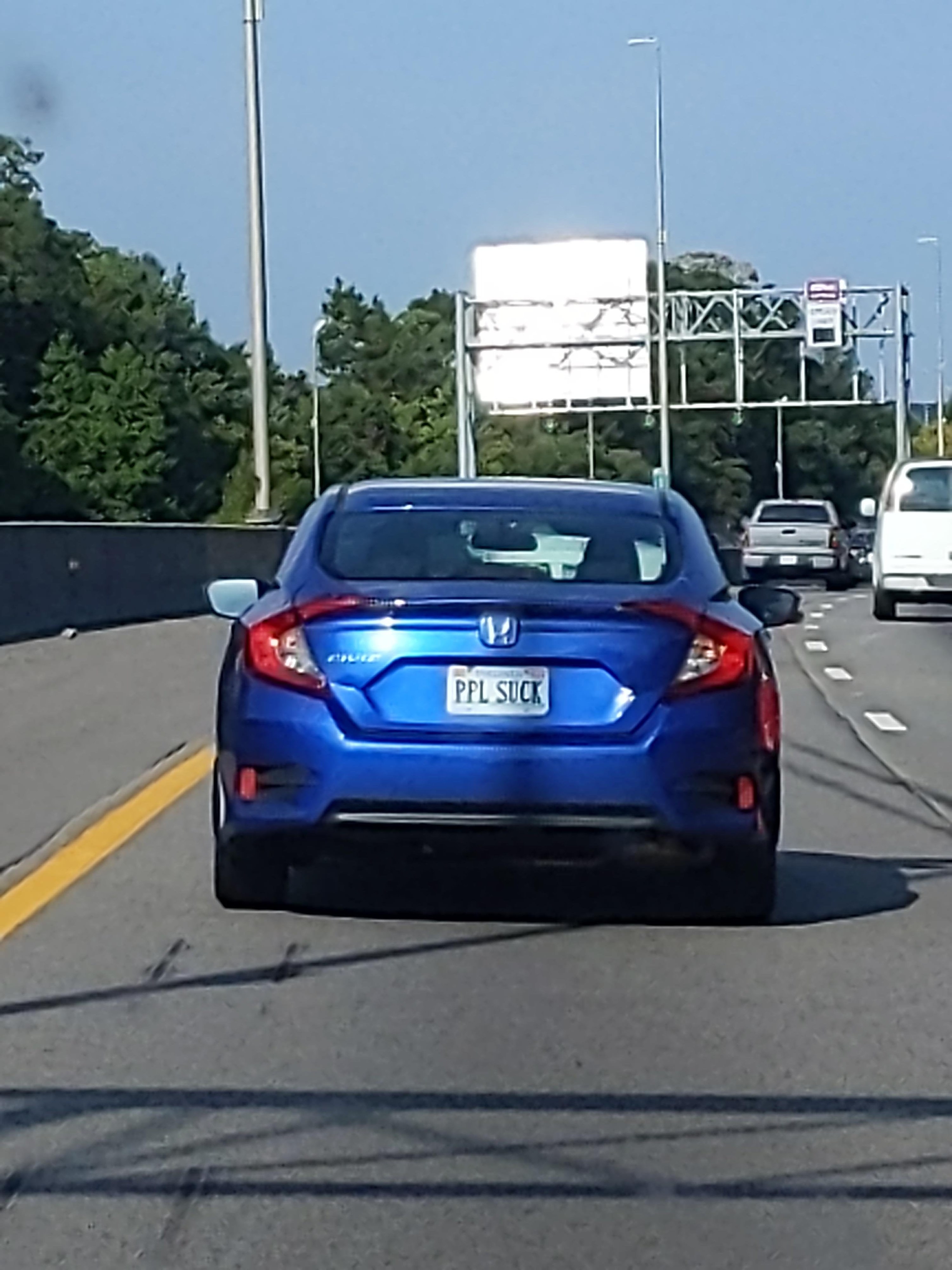 Car with license plate reading &quot;PPL SUCK&quot;