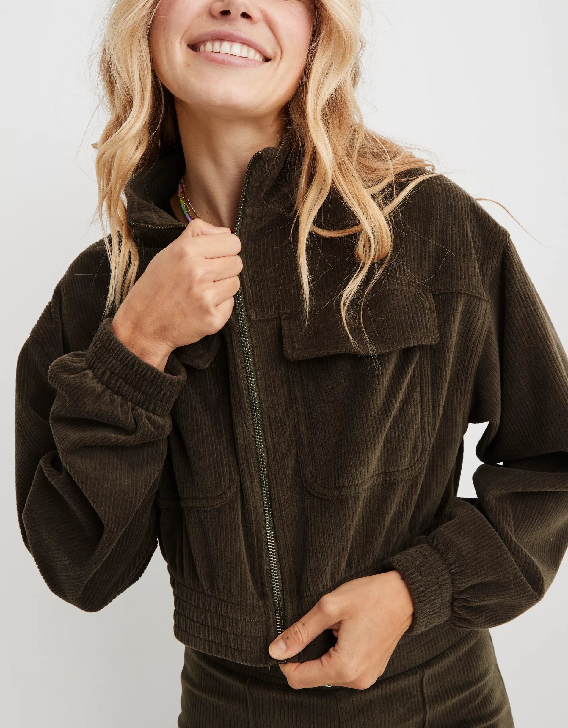 a model wearing the olive green velour jacket